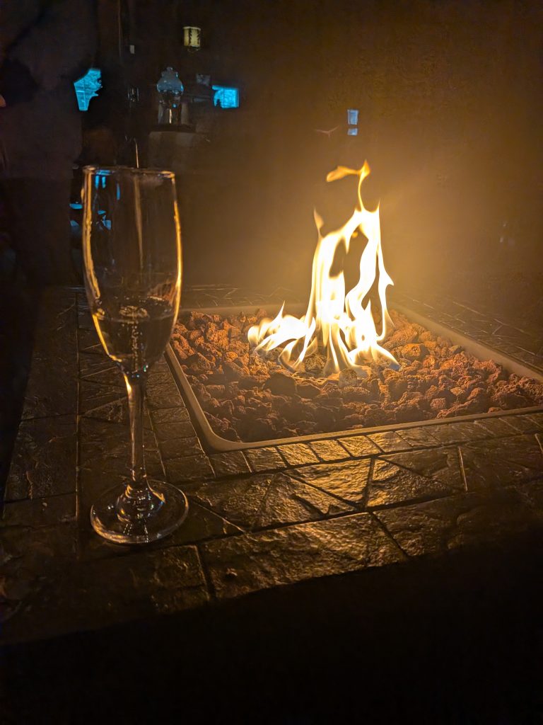 sparkling wine by the fire pit at Mongata
